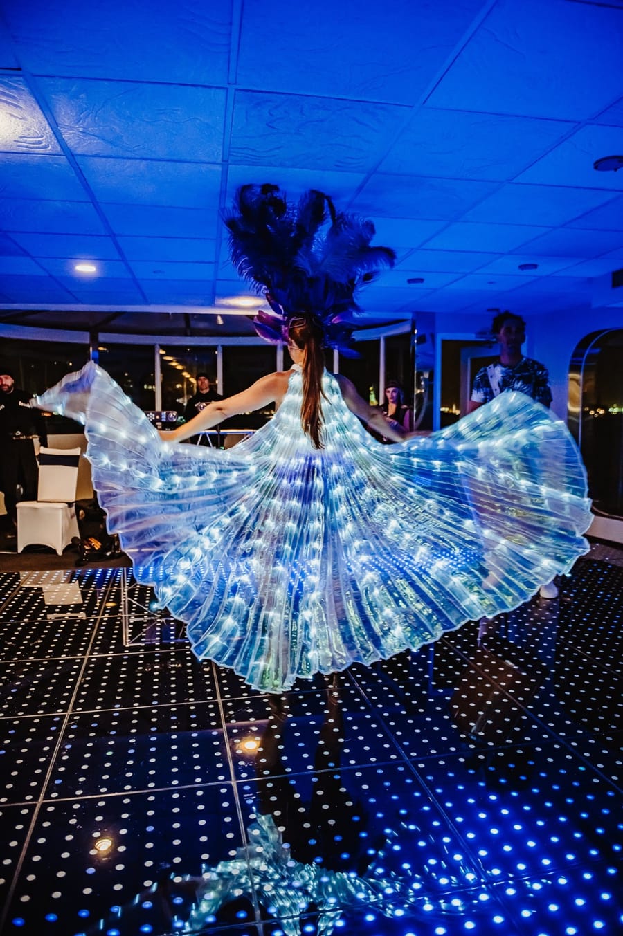 Illuminated LED dance floor with a performer in a light-up costume