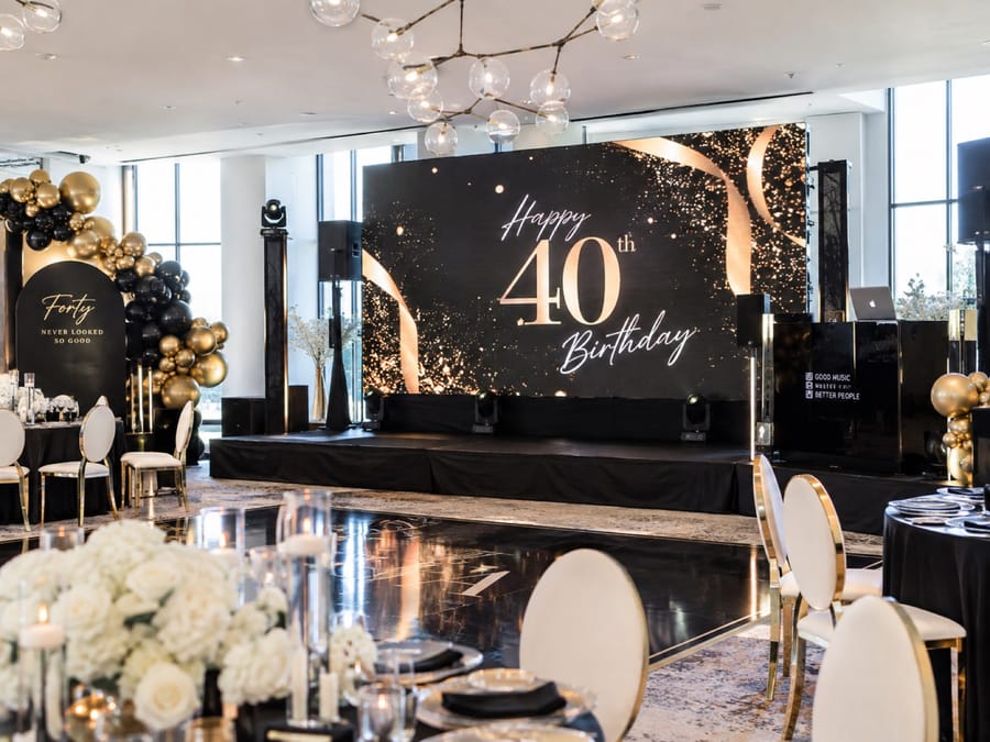 LED screen showing a black and gold 40th birthday design above a dance floor